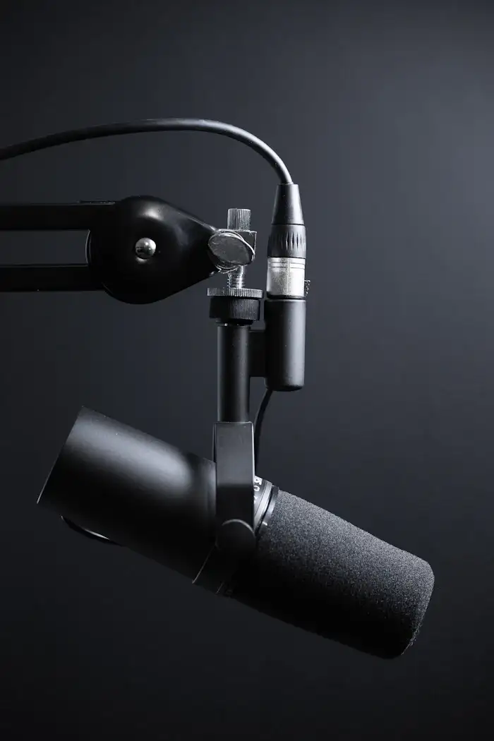 A podcast microphone on a boom arm