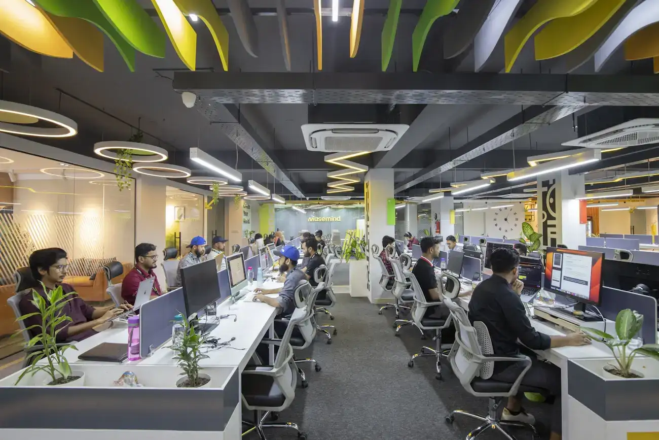 A busy open-plan office with people working at their desks