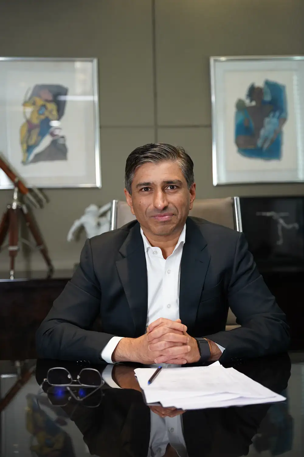 A business owner in a suit at his desk