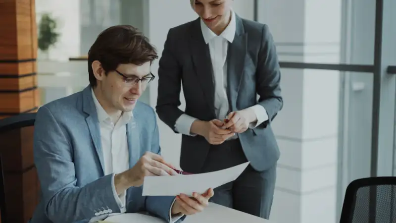 A manager reviewing a document with a colleague