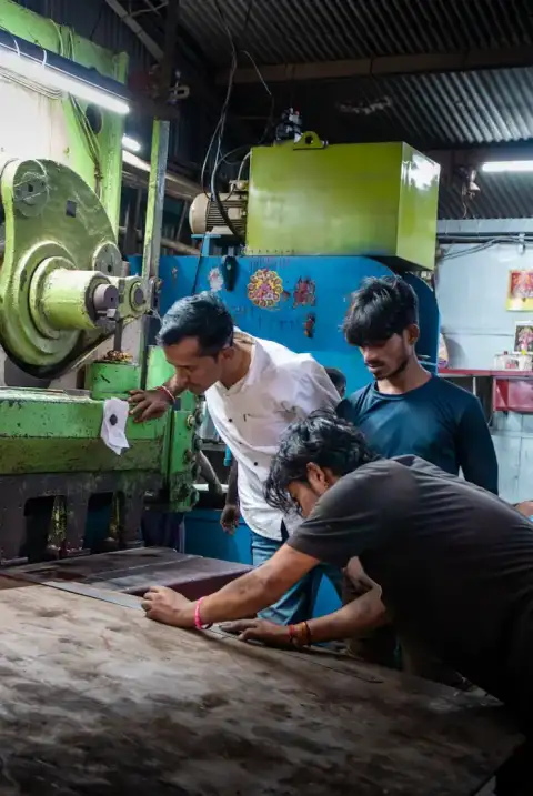 Workers operating machinery at a manufacturing plant